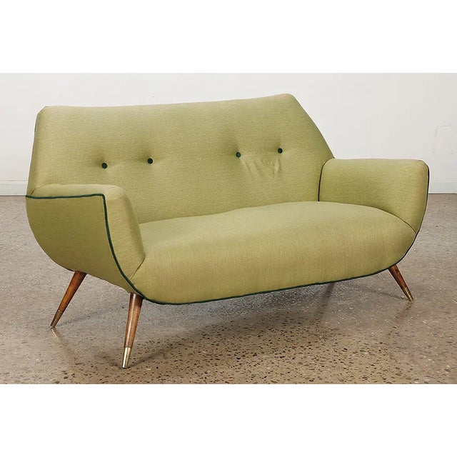 This stunning vintage modern Italian loveseat embodies the elegance and sophistication of iconic 1950s Italian design....