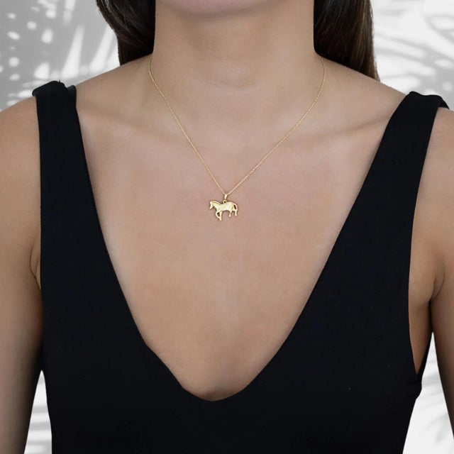 The captivating Balance Zebra Pendant Gold Chain Necklace, a true testament to grace and style.The focal point of this...