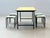 Charming swiss-made table set consisting of a rectangular metal table and four matching stackable stools. The tabletop...