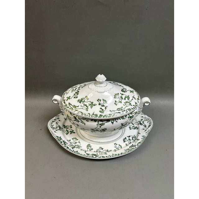 An elegant vintage porcelain soup tureen with a matching fitted lid and undertray platter from the renowned Portuguese...