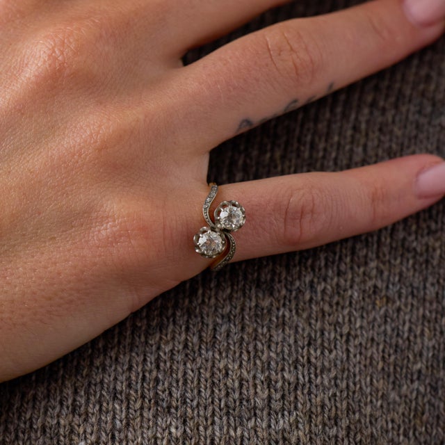 This elegant Edwardian toi et moi ring is a beautifully romantic jewel from the 1910’s, centered by 2 old European cut...