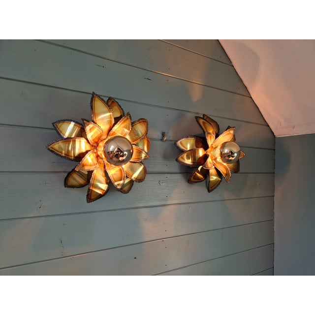 Pair of floral brass wall sconces in the hollywood regency style, produced by maison jansen (france) in the 1970s. they...