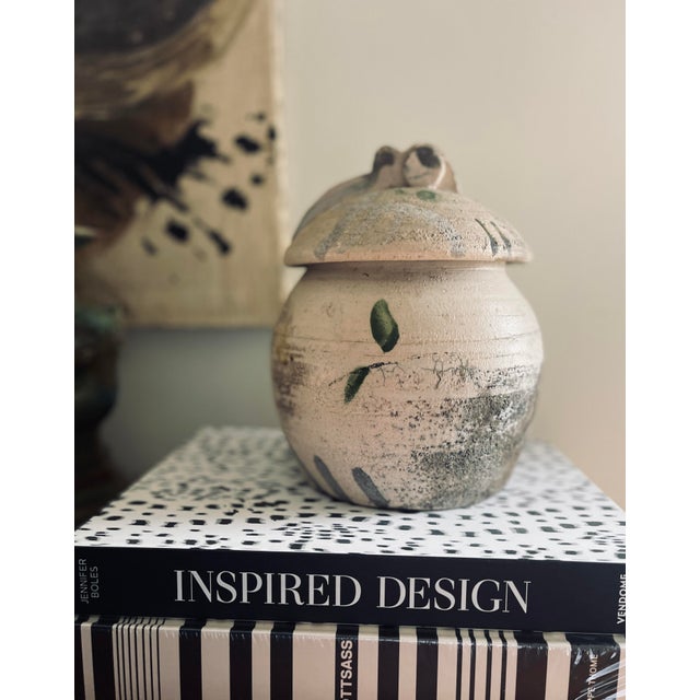 Beautiful piece of glazed pottery, it has a very unique shape that adds to its charm. A round body with a round lid that...