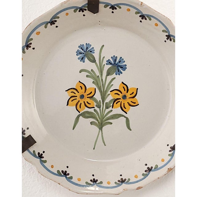 A 19th-century French faïence plate. Chips to rim.
