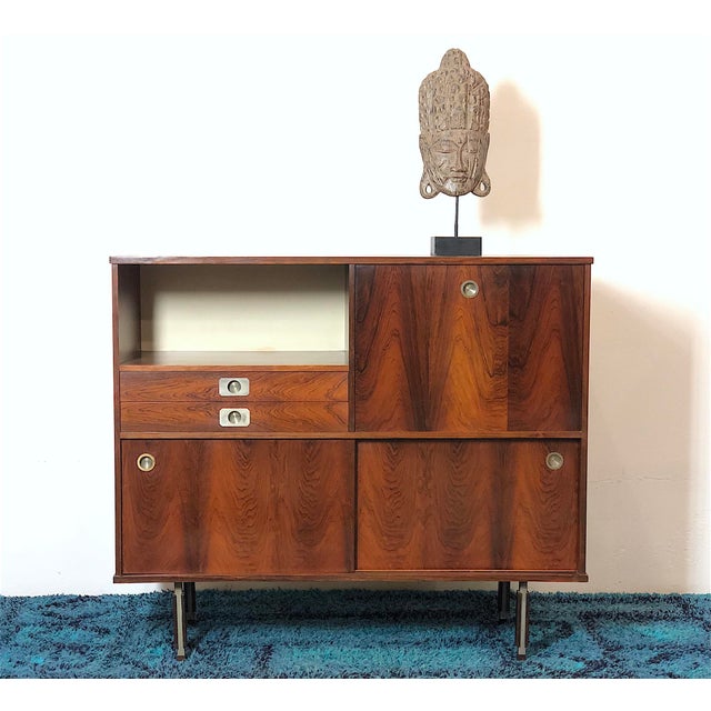 1960s Rosewood Highboard. Minimalist and elegant design for this highboard made entirely of rosewood. The cabinet is made...