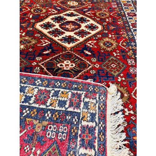 Expertly handknotted from pure wool, this vintage Yalameh rug pairs a deliciously soft feel underfoot with a resilient,...