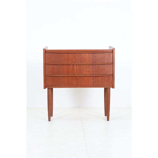 1960s, Denmark. Teak veneer. Overall dimensions approx.: 67 x 62 x 29 cm (height, width, depth). Used item. Extensively...