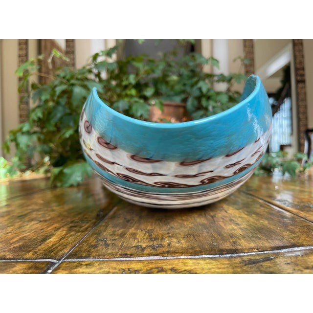 Ivory, turquoise, taupes combine to create this one-of-a-kind oval folded bowl. Made in Italy by Murano glass artisans.