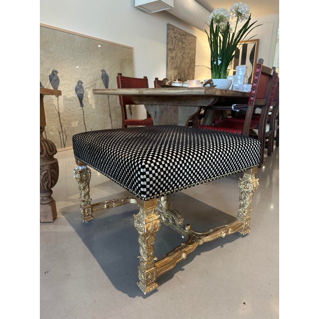 This ornate antique-style ottoman features a richly carved giltwood base with intricate floral, acanthus, and scrollwork...