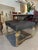 This ornate antique-style ottoman features a richly carved giltwood base with intricate floral, acanthus, and scrollwork...
