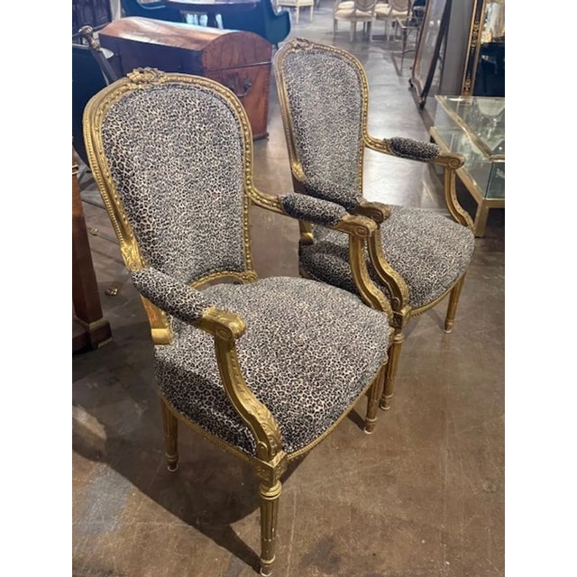 Good pair of French Louis XVI style carved and giltwood armchairs with leopard print upholstery. Celebrated for their...