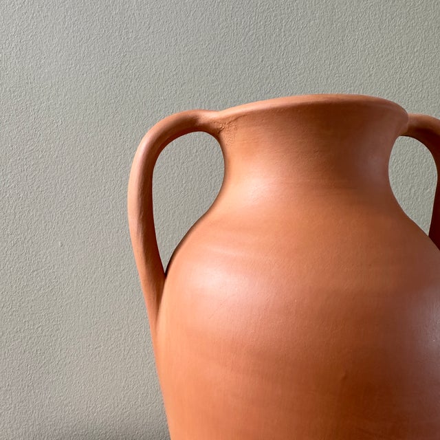 Description Traditionally used to collect and transport water, this handmade terracotta amphora is one-of-a-kind and will...