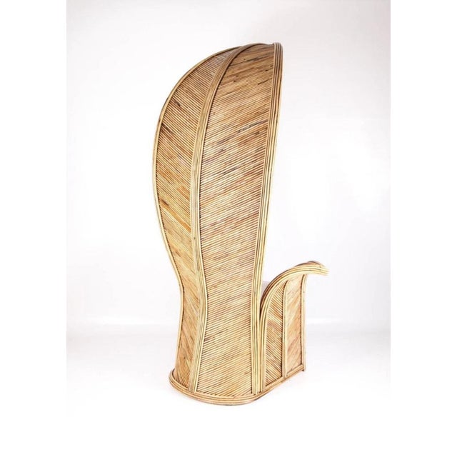 Very large palm-shaped rattan armchair. Very decorative sculptural piece of high quality since it is entirely handmade....