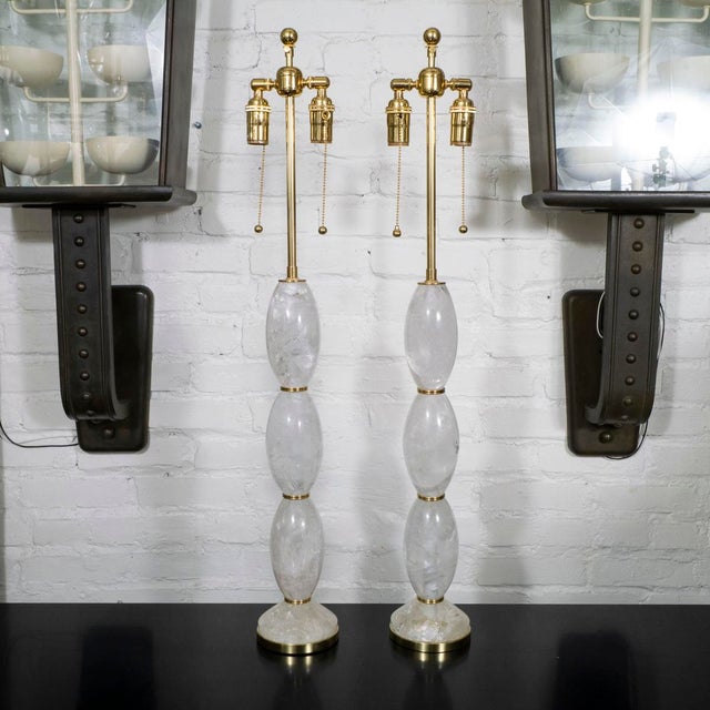 Pair of barrel shaped rock crystal table lamps with brass hardware by Spark Interior.