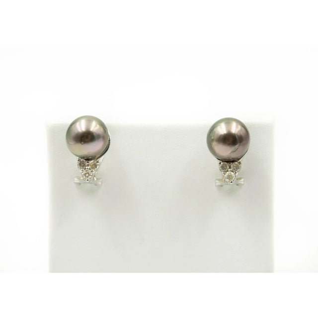 Grey pearl stud earrings with .19 carats of diamond accents mounted in 18k white gold. The back is an omega with a post....