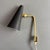 Beautiful mid-century design wall lamp. Perforated black-lacquered metal shade, bracket in brass. Made by Swedish renown...