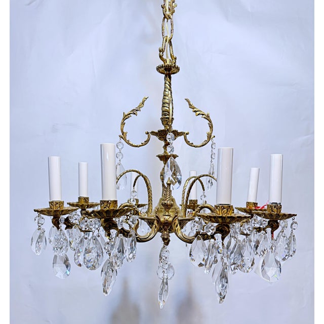 This is a Spanish style bronze chandelier with ornate designed frame and dressed with almond style hand cut crystal. It...