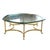 This coffee table channels Hollywood Regency glamour with its shaped beveled glass top resting atop an ornate brass base,...