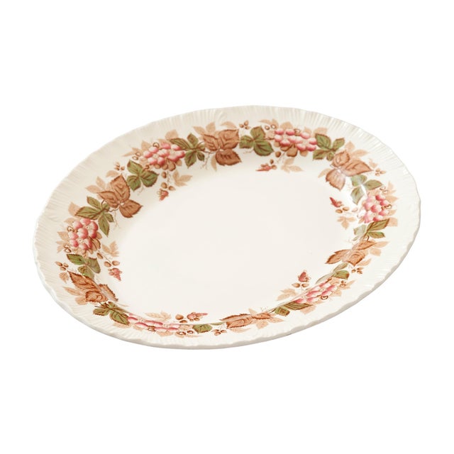 An English Wedgwood ceramic serving platter in the “Wild Briar” pattern. A rich floral border of sweetbriar roses in pink,...