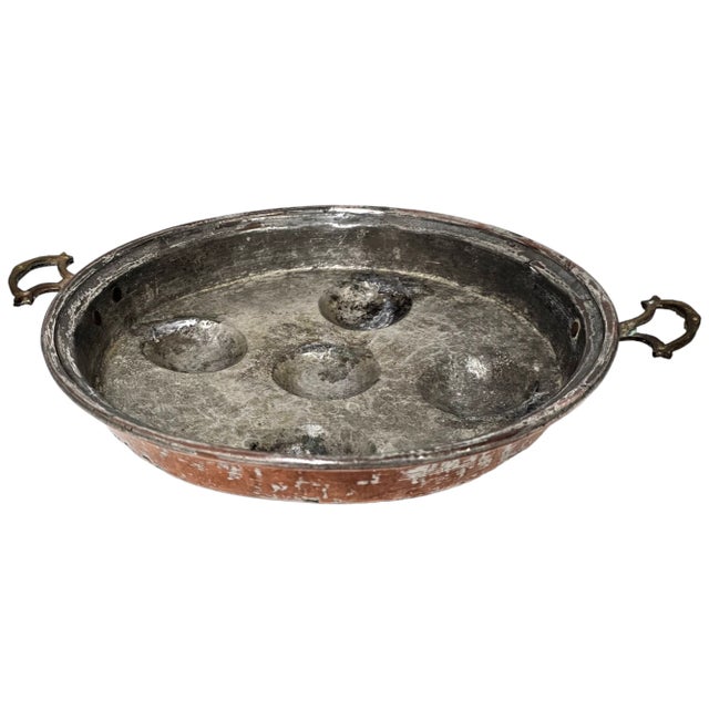 This vintage escargot pan is made of copper, metal and tin. Crafted in France, it shows the traditional craftsmanship and...