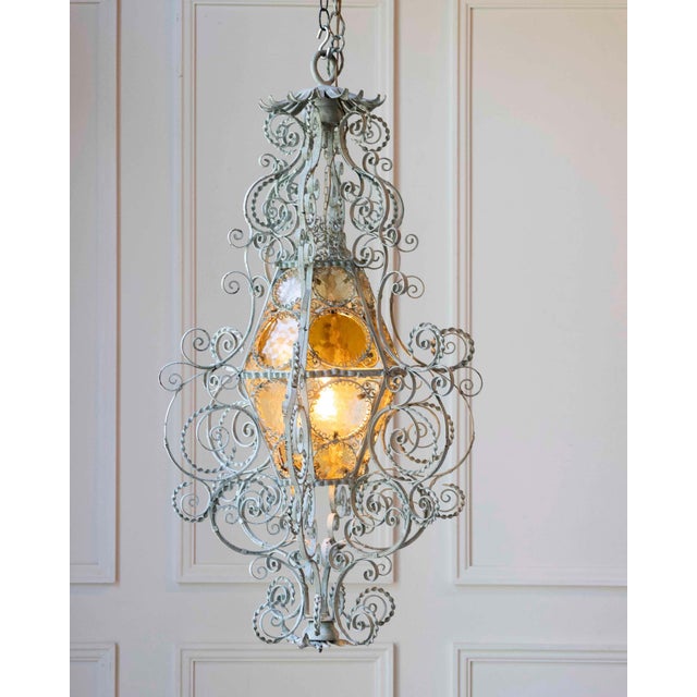 This wrought-iron lantern dating from the early 1900s is a fascinating piece of furniture that combines style and history....