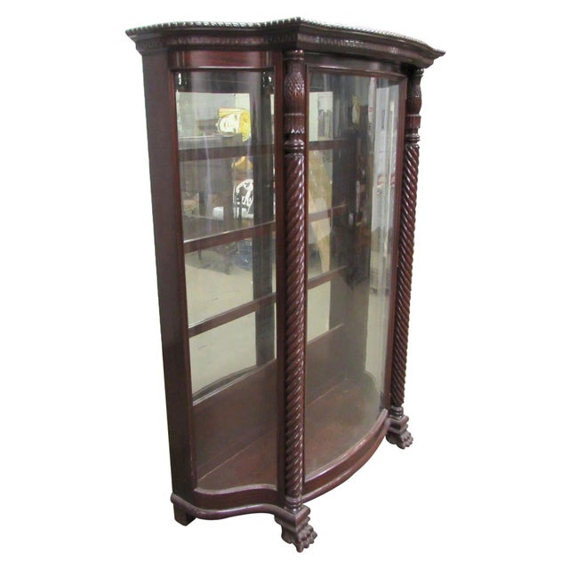 Spanish Revival dark toned cabinet with curving glass panels. This features fantastic carved details starting from the...