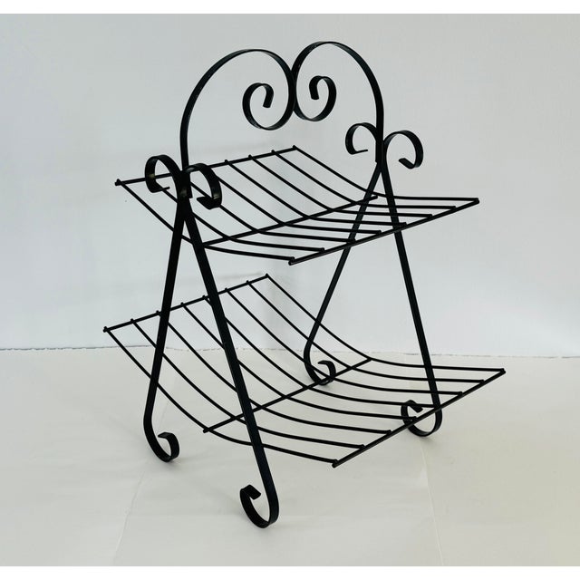 Vintage 1950s Black Metal Two-Tier Magazine Rack. Excellent used condition. Could be used for additional storage types....