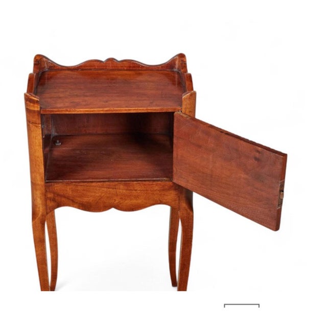 This is a charming French walnut night stand in walnut that is a copy of a 19th century provincial stand. The false...