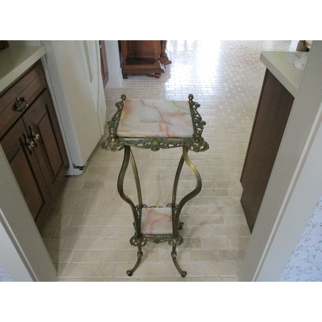 This Antique Brass Marble Ornate Rococo Gueridon Candle/Plant Lamp Table Pedestal is a stunning piece of furniture with a...