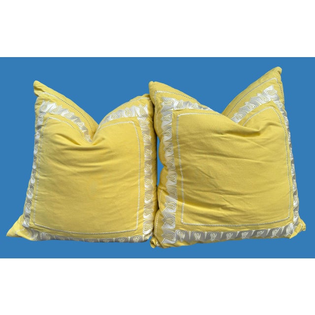 Large bright yellow linen pillows with white stitching design. Made by Echo. 24”x 24” duck down inserts, with zipper.