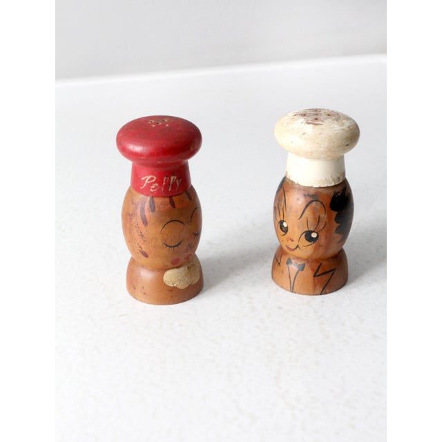 This is a pair of mid 20th century vintage wooden salt & pepper shakers by Woodpecker Woodenware of Japan. Cheeky, hand-...