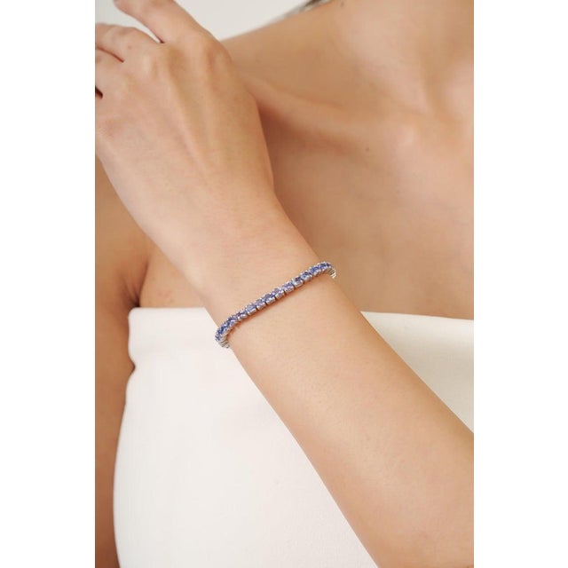 This elegant tennis bracelet is crafted in 925 sterling silver and beautifully set with 46 natural Tanzanite gemstones...