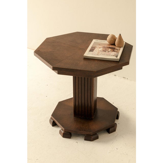 Geometrically shaped side table produced in Belgium around 1940. This octagonal Art deco table in dark stained wood...