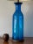 A massive glass lamp by Blenko. Bottle shaped blue glass, measuring 23.75" H, excluding shade.