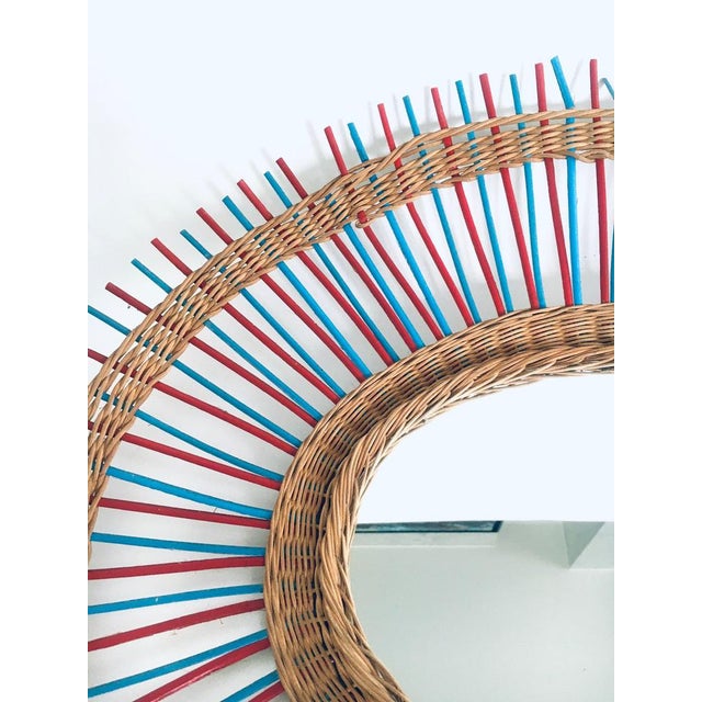 Vintage French Riviera Wicker Oval Wall Mirror. Made in France, 1950s. Braided wicker with blue and red colored wooden...