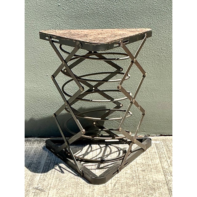 This vintage industrial side table pairs a richly patinated stone top with a sculptural metal scissor-lift base, capturing...