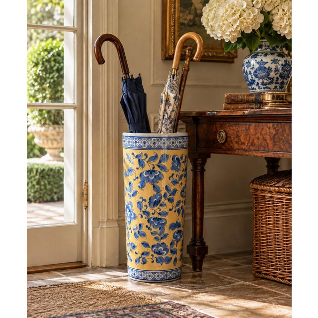 A classic blue, white, and yellow porcelain umbrella stand in the chinoiserie tradition, featuring Asian floral designs....
