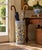 A classic blue, white, and yellow porcelain umbrella stand in the chinoiserie tradition, featuring Asian floral designs....