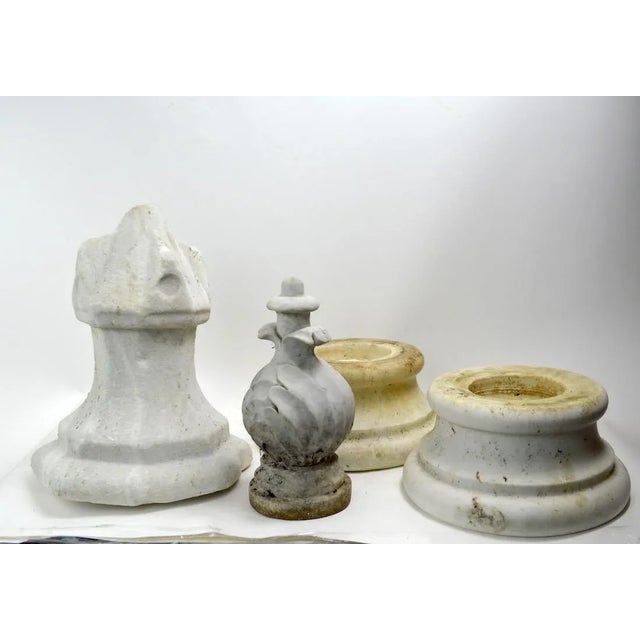 Group of four marble fragments to include two pedestal bases (9.5" D x 5" H) and two finials taller 11" H Shorter 10"....