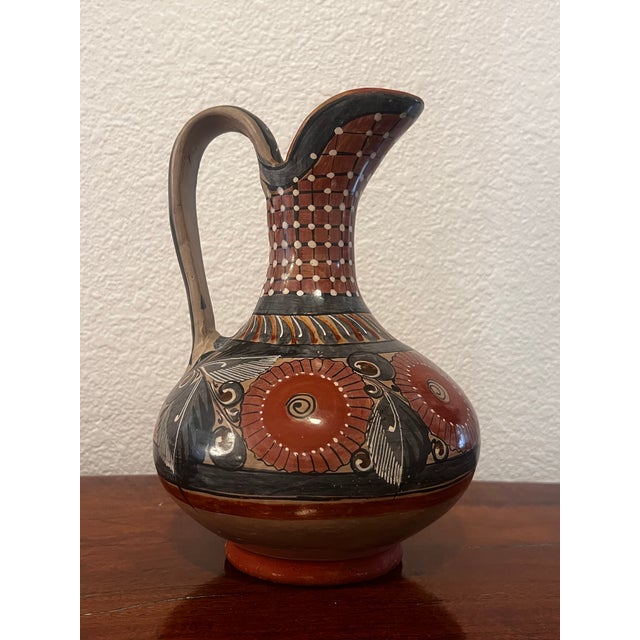 Vintage hand-painted and glazed folk art earthenware pitcher vase from the Tonala Jalisco region of Mexico.