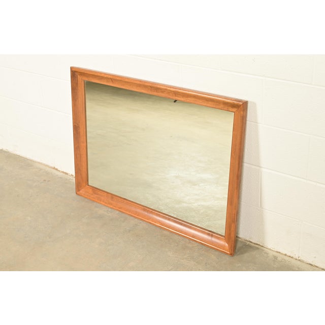 A gorgeous Early American or American Colonial style solid maple framed mirror By Ethan Allen USA, Circa 1980s Measures:...