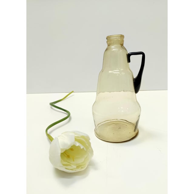 Made in Italy, 1910s. This pitcher vase is made in transparent pagliesco blown glass and the external surface is slightly...