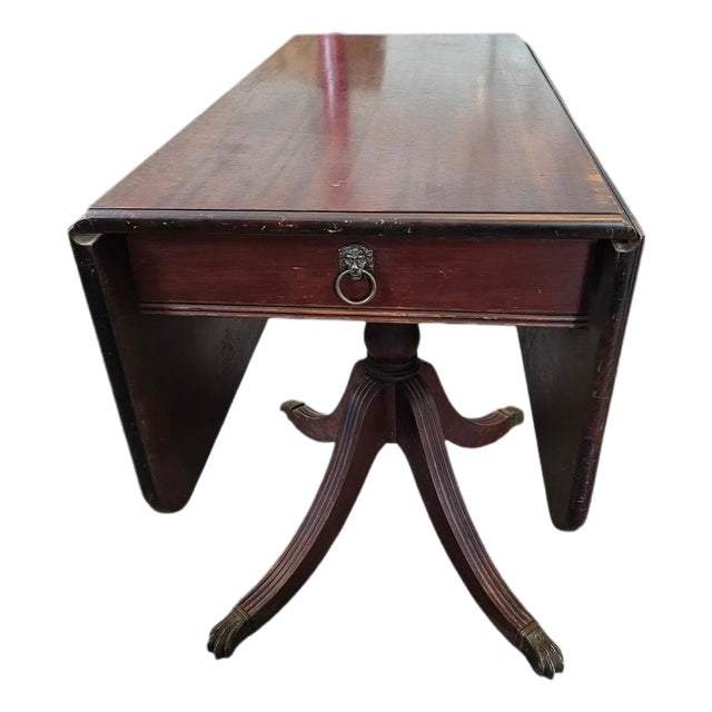 Antique Duncan Phyfe Mahogany Drop-Leaf Pedestal Table With Brass Feet For Sale