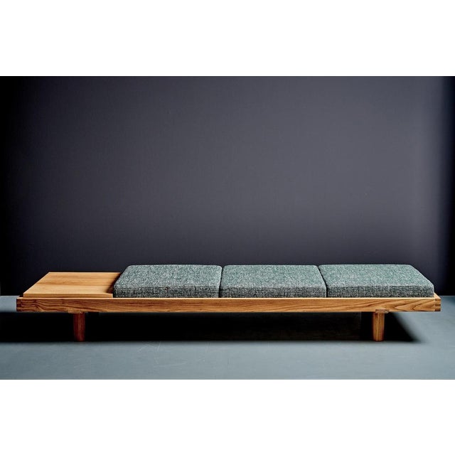 A minimalist daybed L 09 by Pierre Chapo, crafted in solid elm with beautifully pronounced grain. Three loose seat...