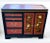 This Asian style server is finished in an oxblood red with black and gold embellishments. The two doors feature stylized...