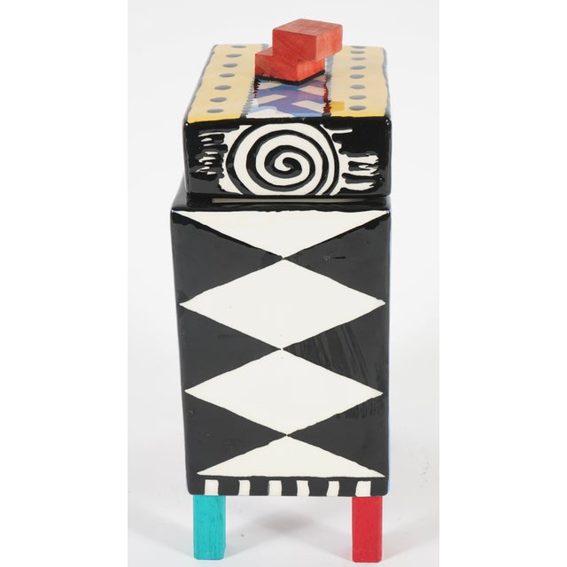 This is a D. Goke 1992 Pandemonium Key West ceramic box.This piece is described as a postmodern Memphis style art block.It...
