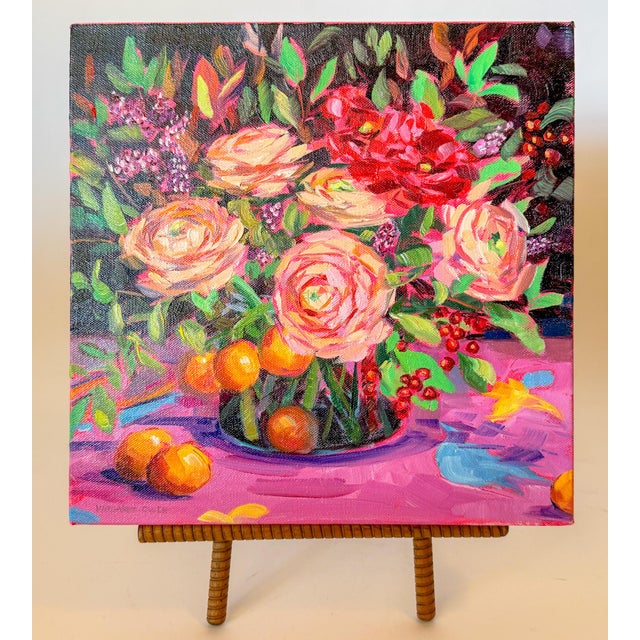 A lovely, vibrant floral bouquet of Ranunculus and Oranges set in a contrasting background of rich blacks and magenta, and...