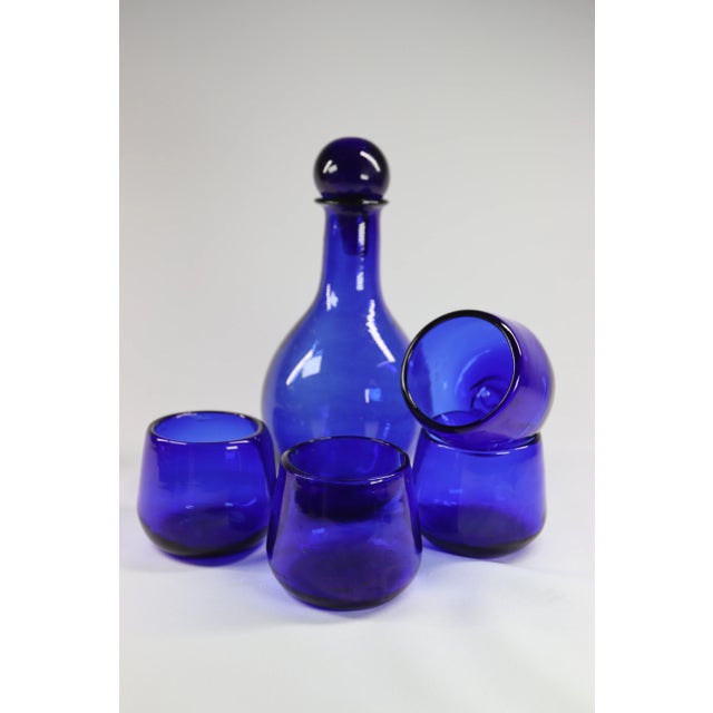 Vintage Set of Cobalt Blue Hand Blown Glass consisting of a carafe + stopper and 4 lowball glasses. Beautiful blown glass...