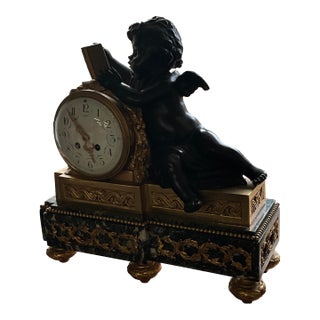 3 Pieces French Mantel Clock 3 Piece .19th Century, Crafted Bronze Figures of Cherub Holding a book.Gilt Bronze and Deep Green Marble For Sale