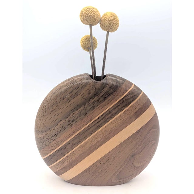 Offered is a hand-turned and lathed vase crafted of segmented Black Walnut and Maple woods created and signed by Warren...